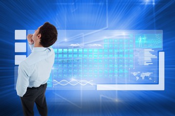 Composite image of thoughtful businessman with hand on chin