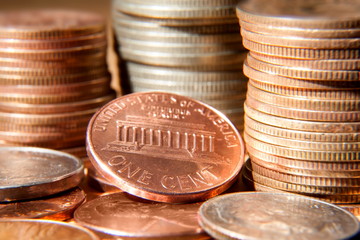 One cent coin against other coins. © anry196411