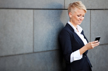 Attractive businesswoman using smart phone