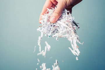 Hand with shredded paper - 61396337
