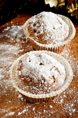 Small cherry cakes with a sugar powder on a table in the kitchen