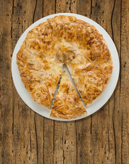 Burek, turkish cake, filo pastry, cutting pieces on old wood