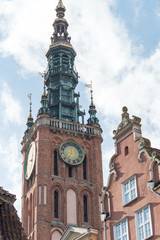 Fototapeta na wymiar The tower of city hall with clock in Gdansk, Poland