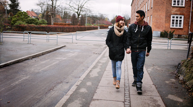 Young couple walking on a sidewalk