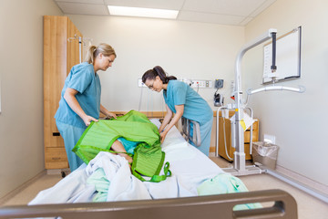 Nurses Preparing Patient Before Transferring Him On Hydraulic Li