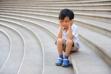 Boy angry and frustrated on the stairs - 61401302
