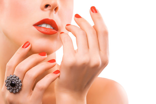 face and beautiful red manicure. isolated