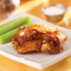 bbq buffalo chicken wings with ranch dip and celery