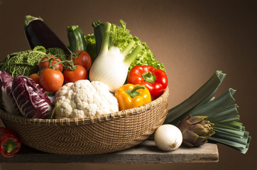 still life with vegetables isolated on brown background