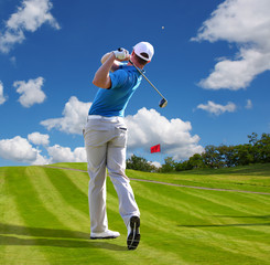 Man playing golf against blue sky