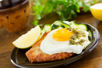 Wiener schnitzel with fried egg and capers.