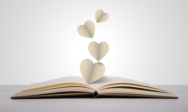 Paper cut of heart on old book