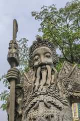 Chinese stone statue in Wat Pho, Bangkok, Thailand.Chinese stone