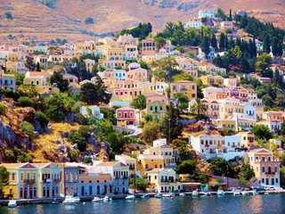 Colorful houses on hill, Symi island, Greece