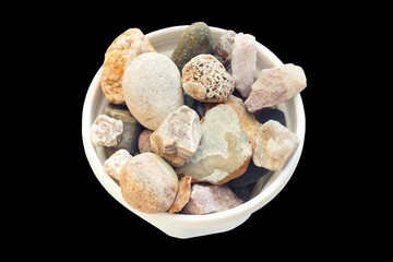 A pile of stones in a white pot.