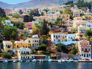 beautiful houses on hill, Symi island, Greece - obrazy, fototapety, plakaty