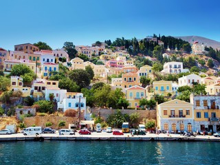Colorful houses on hill, Symi island, Greece - obrazy, fototapety, plakaty