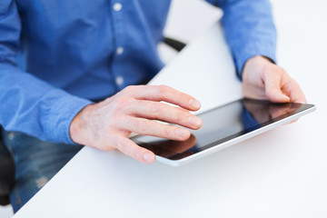 close up of male hands working with tablet pc