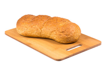 Fresh baked loaf on the wooden cutting board.