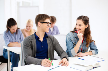smiling students with notebooks at school