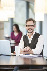 handsome man using  laptop in a cafe