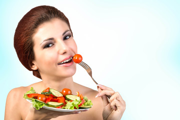 Young Beautiful Girl eating Fresh Vegetables Salad.Vegetarian