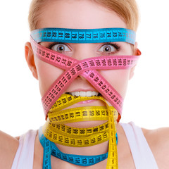 Obsessed fit woman with measure tapes. Time for diet slimming.