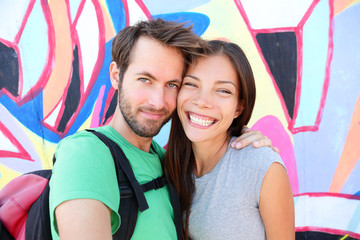 Happy couple selfie portrait, Berlin Wall, Germany