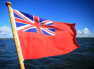 British maritime red ensign flag blue sky
