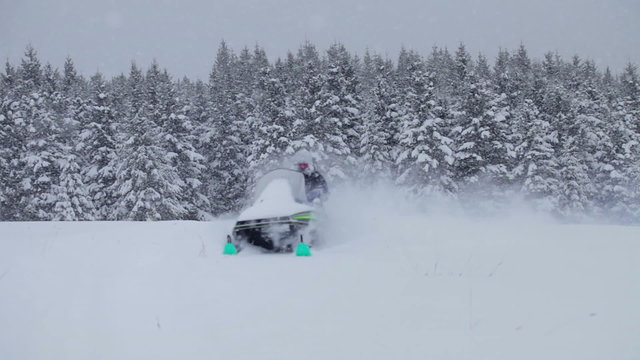 Lonely Man Snowmobiling in The Powder Snow