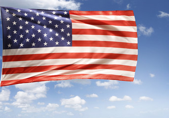 Fototapeta premium American flag flying in blue sky