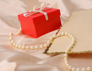 gift on red silk satin background.