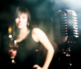 Retro microphone and a female silhouette.