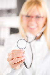 Young female doctor holding stethoscope.