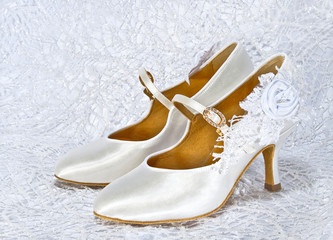 White shoes of bride at wedding shiny fabric