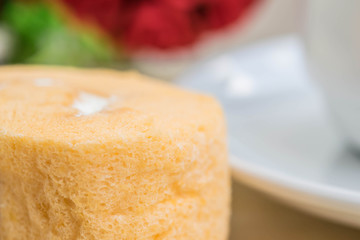 close up  slice roll cake on white plate,orange cake.