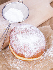 donuts with castor sugar on a wooden table