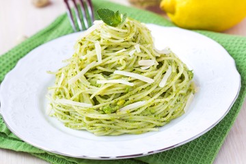 Italian green pasta spaghetti with pesto green peas, mint