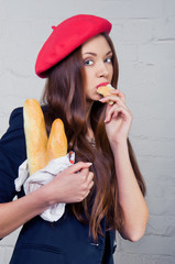 Beautiful young Frenchwoman eating baguette