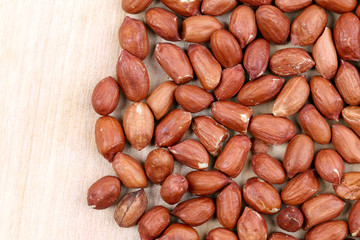 Close up of peanuts. Wooden plate.