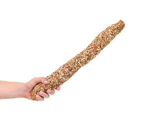 Hand holds long loaf.