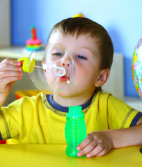 Boys inflates bubbles.