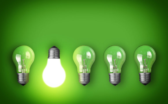 Idea concept with row of light bulbs and glowing bulb