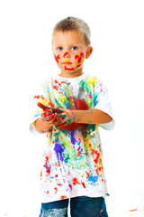 Smiling boy paints paints