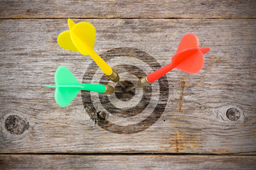 Darts  hitting target on a wooden planks