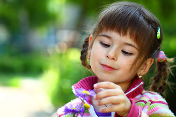Beautiful smiling girl with a flower