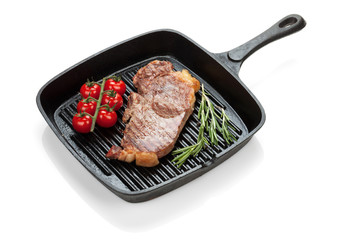Sirloin steak with rosemary and cherry tomatoes cooking in a fry