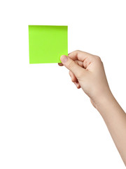 female teen hand holding green sticky note