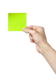 adult man hand holding green sticky note