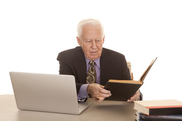 Elderly man business computer look at book
